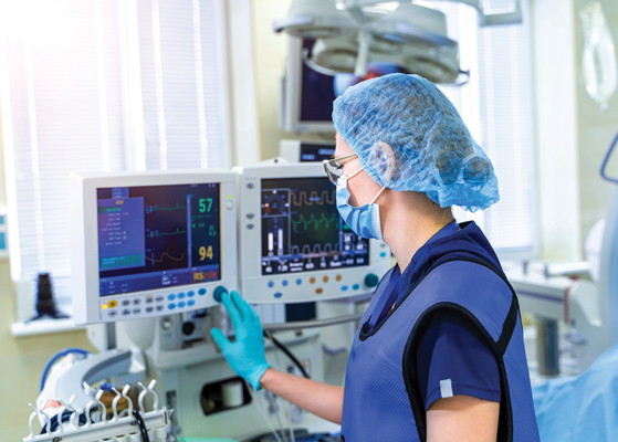 Healthcare worker checking hospital monitors