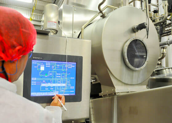 Plant operator utilizing a control panel at the Ovid Michigan MMPA drying plant