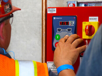 Technician pushing controls on a custom fire alarm system